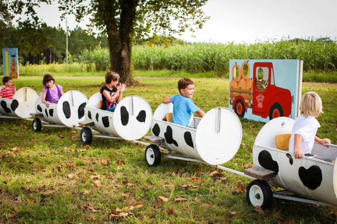 Train decorated as a cow with children riding it
