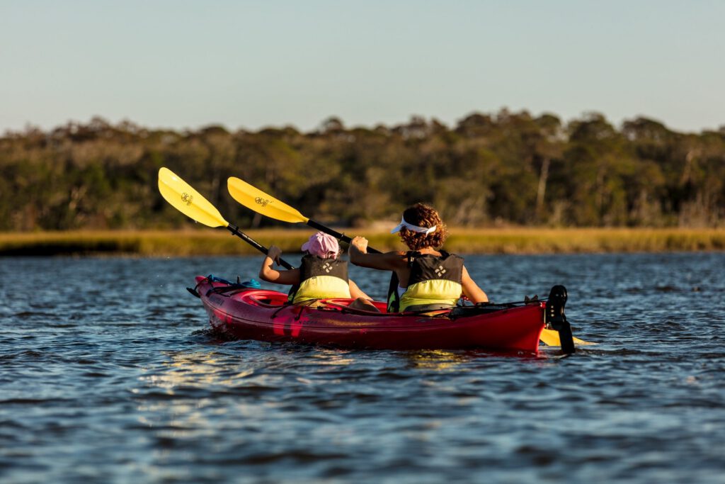 Two kayakers enjoy a day out on the still water.
