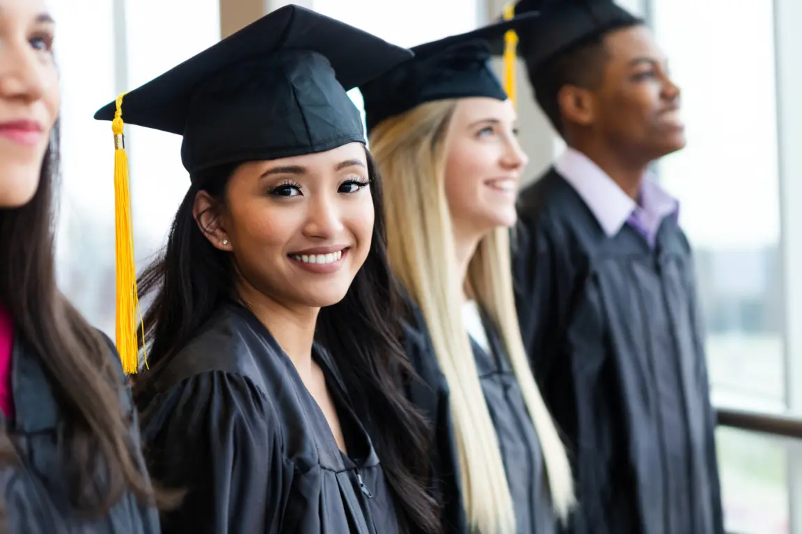 Happy graduates in academic gowns and caps, celebrating achievement and future success.